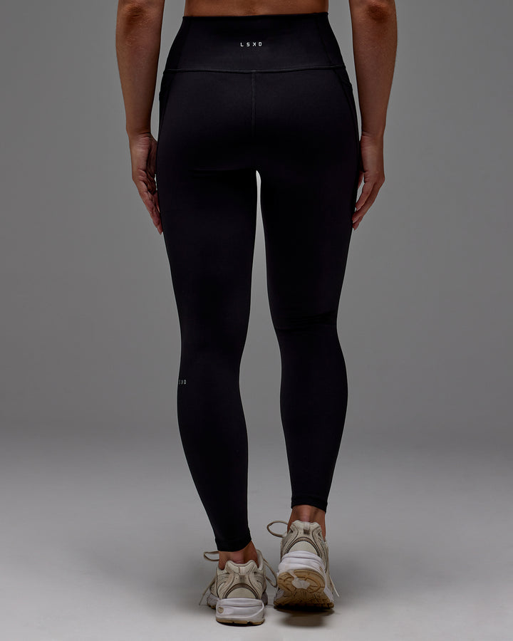 Woman wearing Fusion Full Length Tight With Pockets in Black | Model:Meg | Size:M
