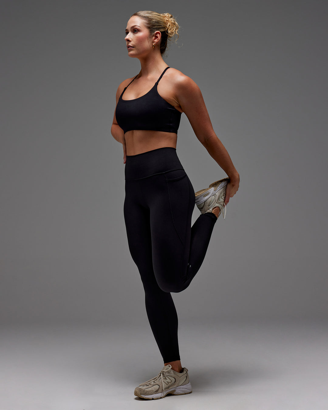 Woman wearing Fusion Full Length Tight With Pockets in Black | Model:Meg | Size:M