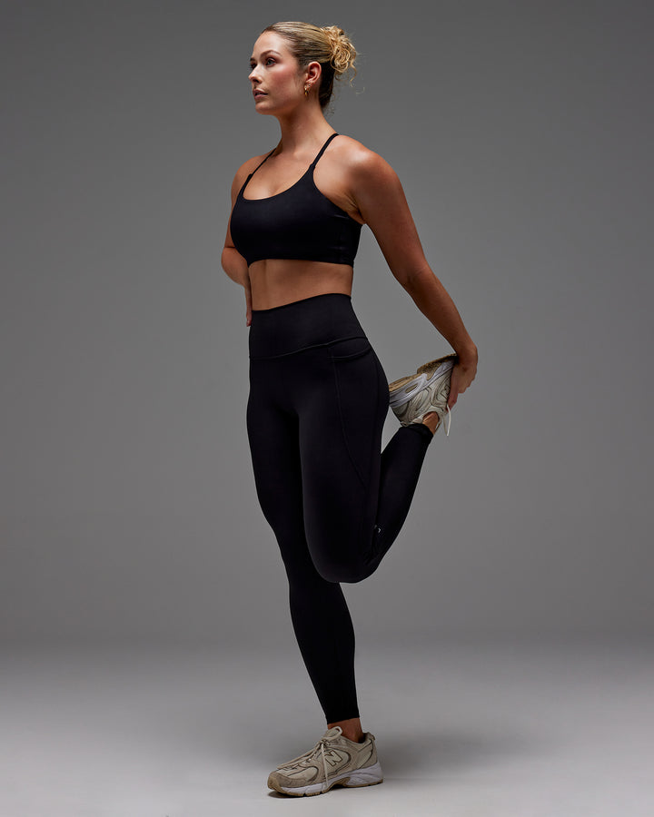 Woman wearing Fusion Full Length Tight With Pockets in Black | Model:Meg | Size:M
