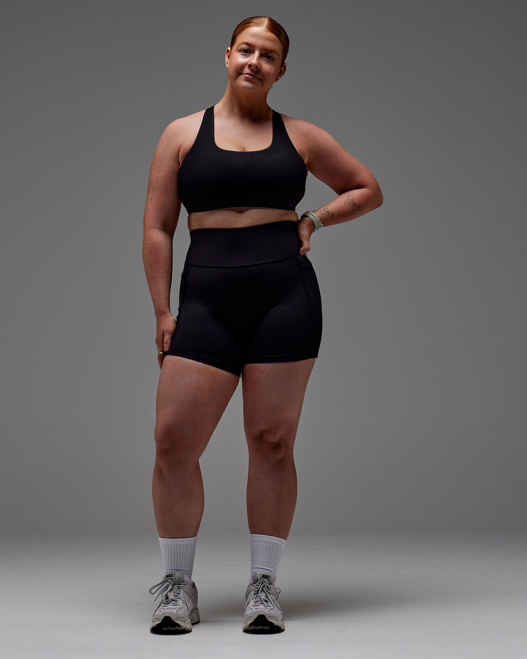 Woman wearing Fusion Ultra High-Rise 6&quot; Short Pockets - Black | Model:Caity | Size:M