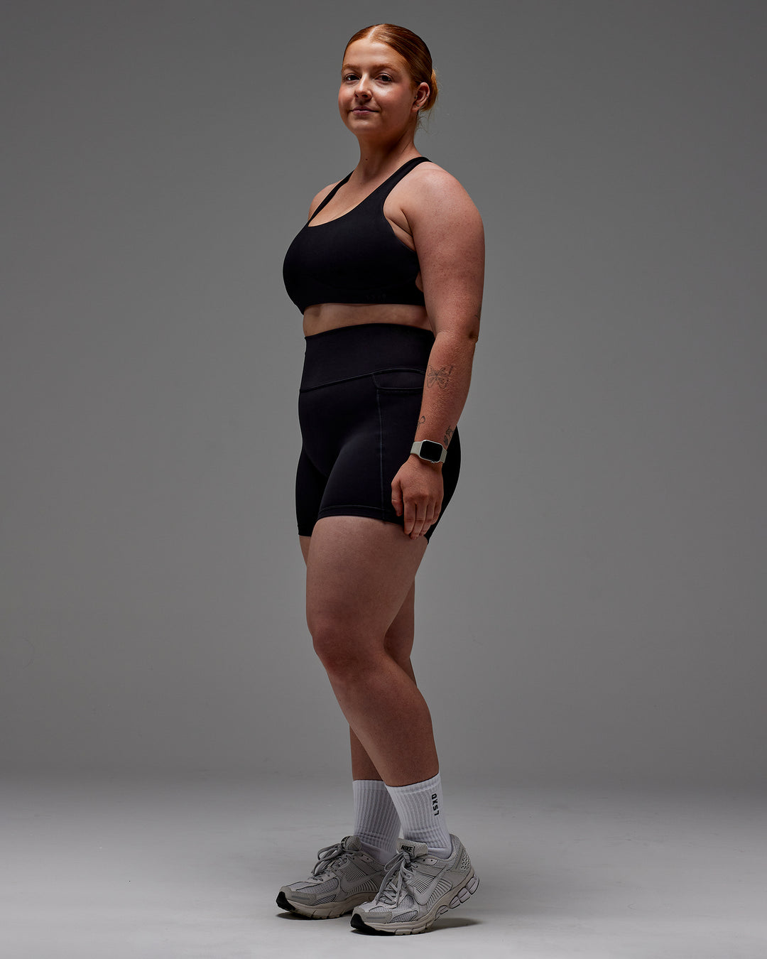 Woman wearing Fusion Ultra High-Rise 6&quot; Short Pockets - Black | Model:Caity | Size:M