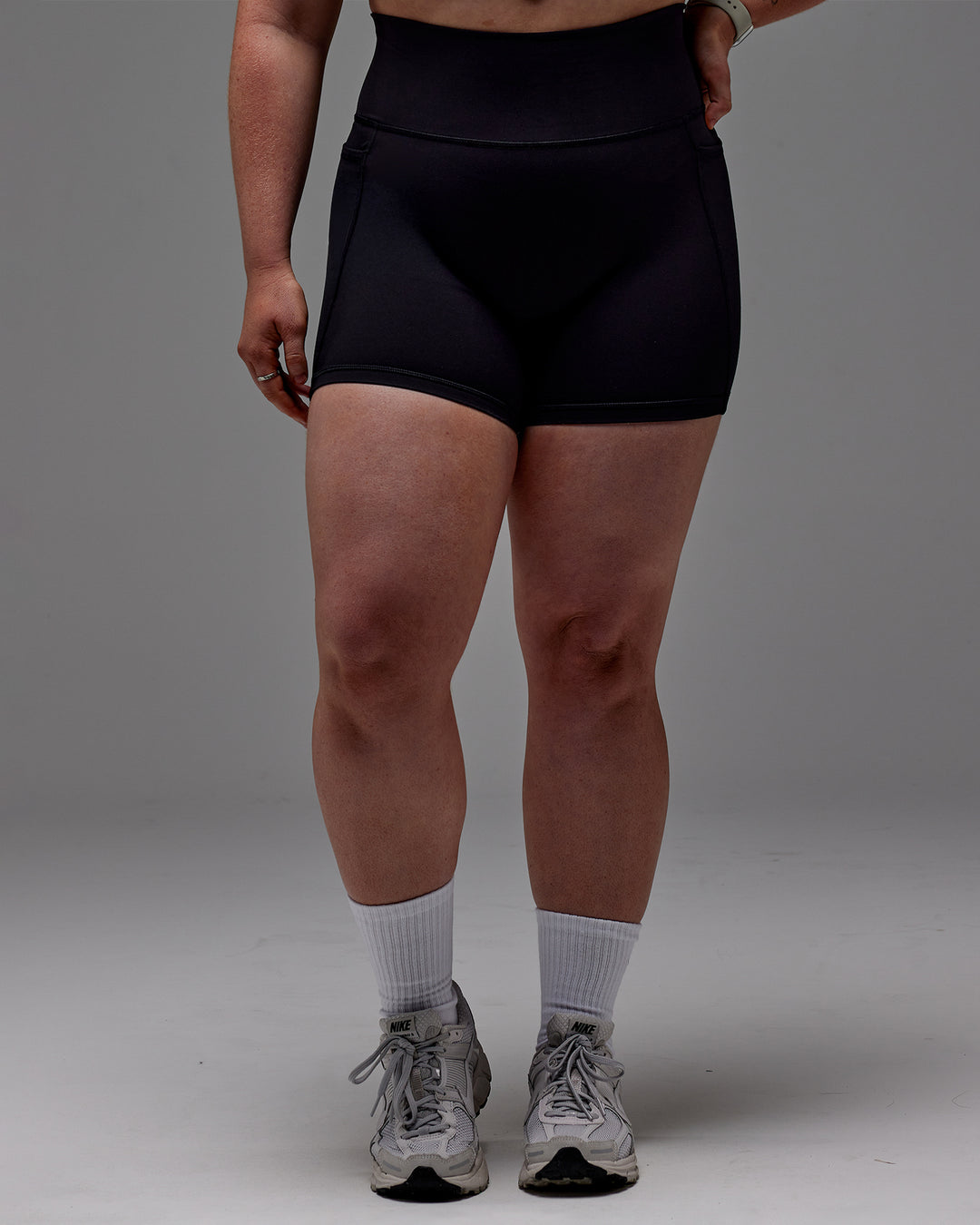 Woman wearing Fusion Ultra High-Rise 6&quot; Short Pockets - Black | Model:Caity | Size:M