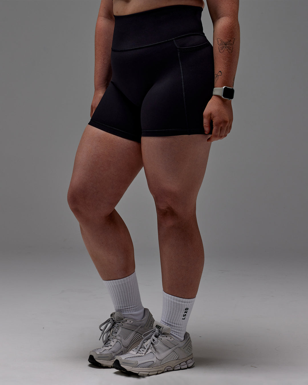 Woman wearing Fusion Ultra High-Rise 6&quot; Short Pockets - Black | Model:Caity | Size:M