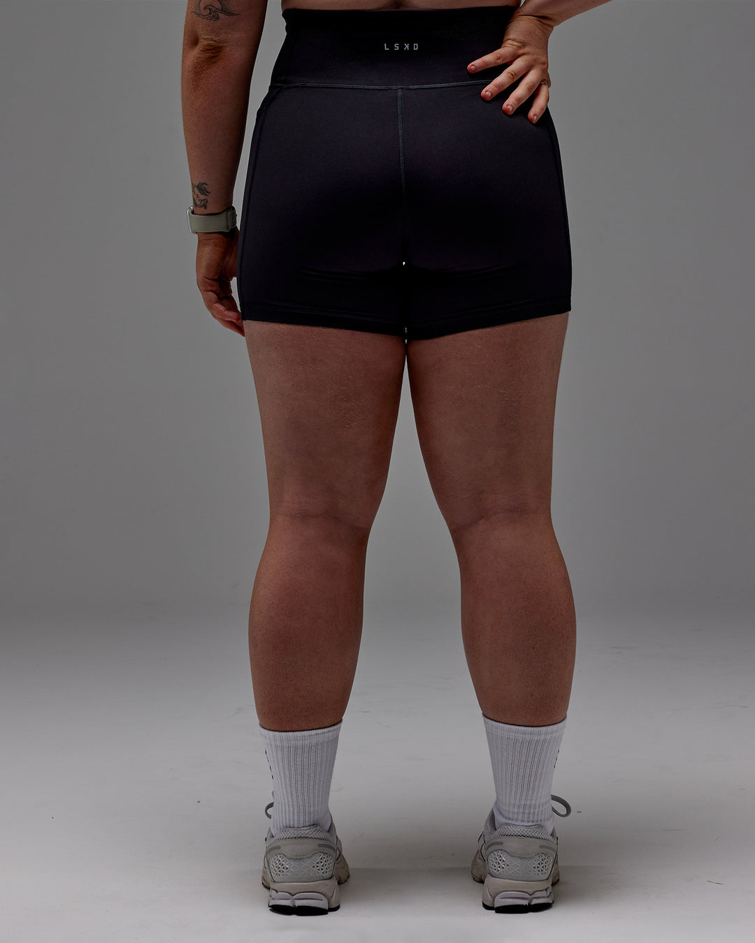 Woman wearing Fusion Ultra High-Rise 6&quot; Short Pockets - Black | Model:Caity | Size:M