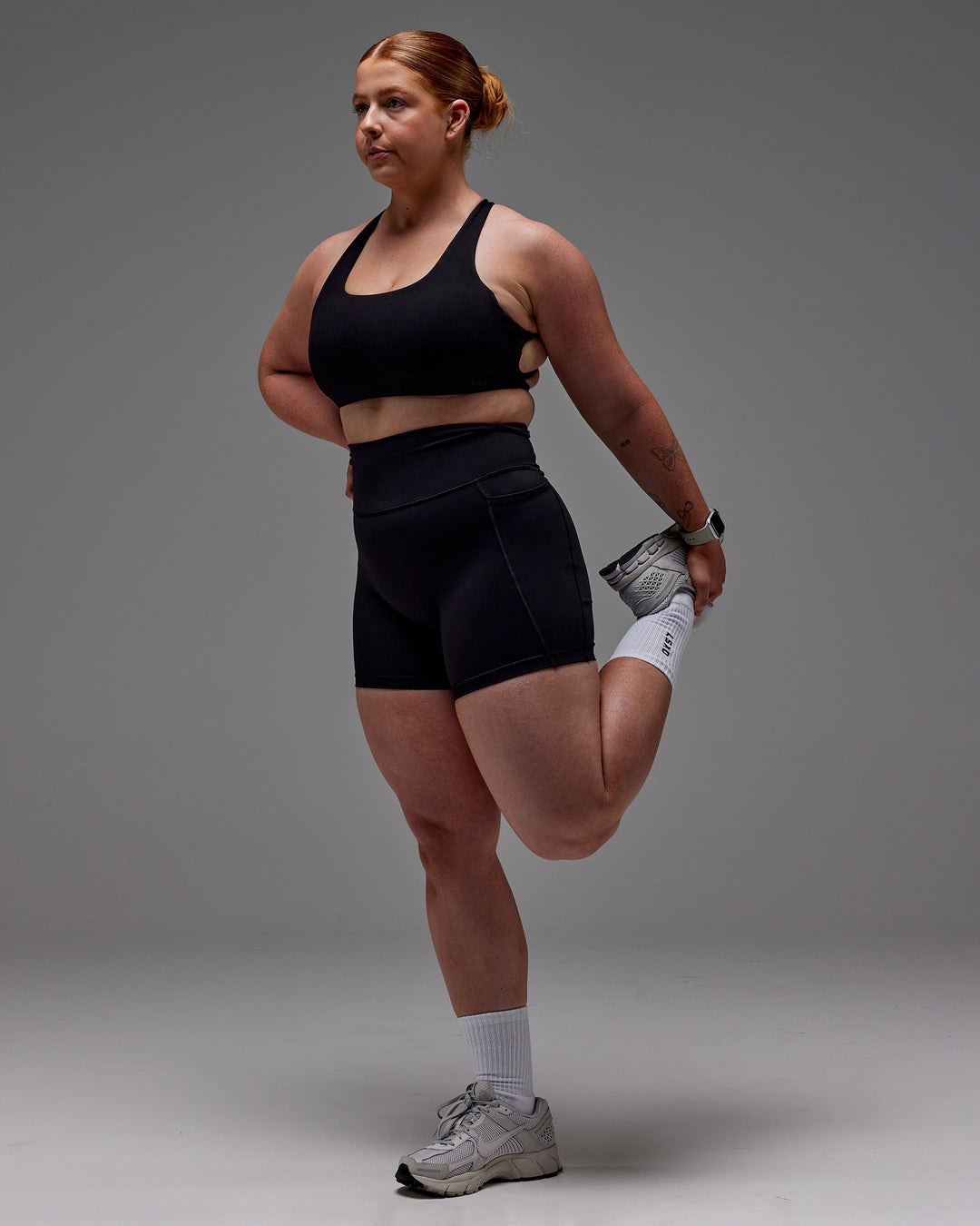 Woman wearing Fusion Ultra High-Rise 6&quot; Short Pockets - Black | Model:Caity | Size:M