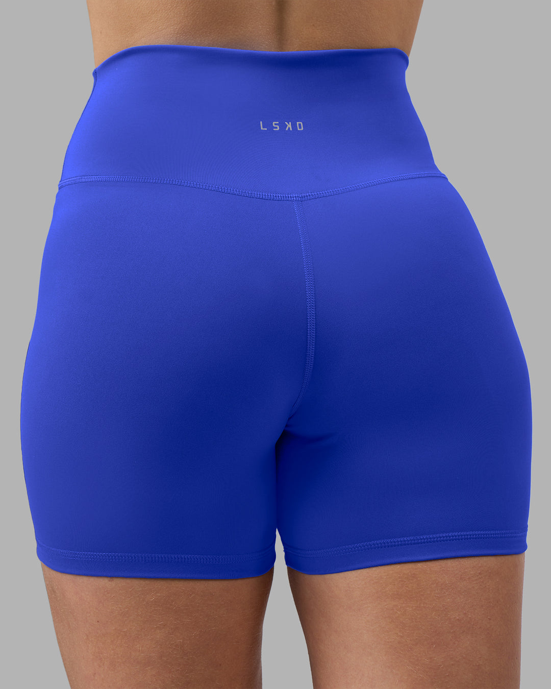 Woman wearing Fusion Ultra High-Rise 4&quot; Short - Power Cobalt | Model:Amy | Size:M