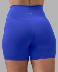 Woman wearing Fusion Ultra High-Rise 4" Short - Power Cobalt | Model:Amy | Size:M