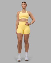 Woman wearing Fusion Ultra High-Rise 6" Short Pockets - Lemon | Model:Amy | Size:M