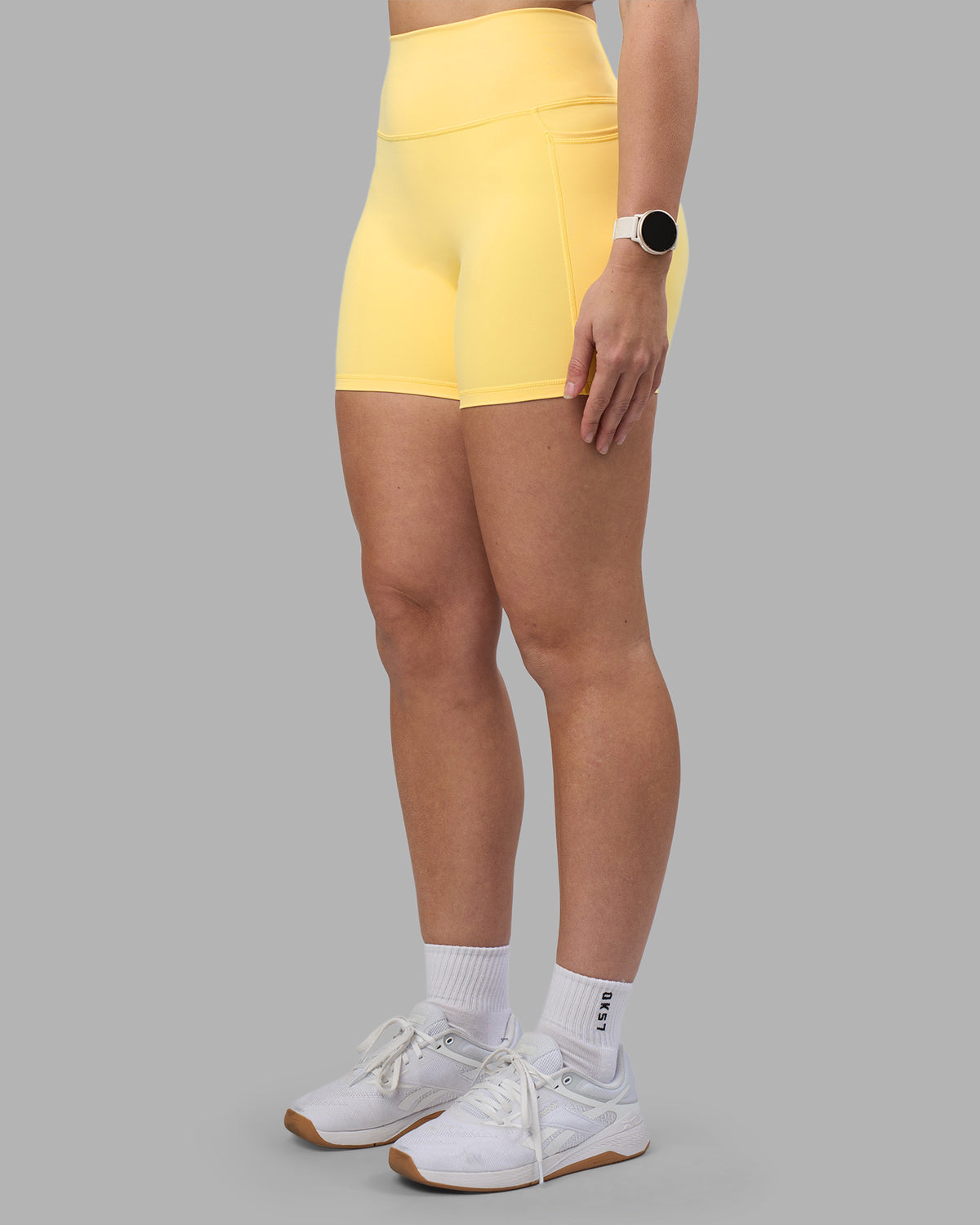 Woman wearing Fusion Ultra High-Rise 6" Short Pockets - Lemon | Model:Amy | Size:M