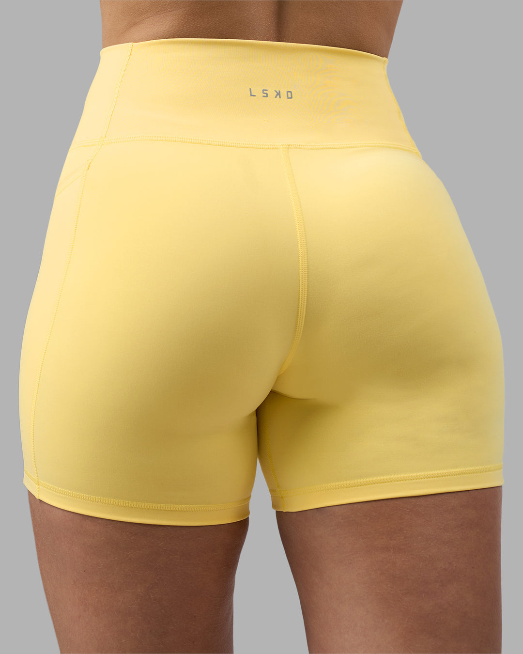 Woman wearing Fusion Ultra High-Rise 6&quot; Short Pockets - Lemon | Model:Amy | Size:M