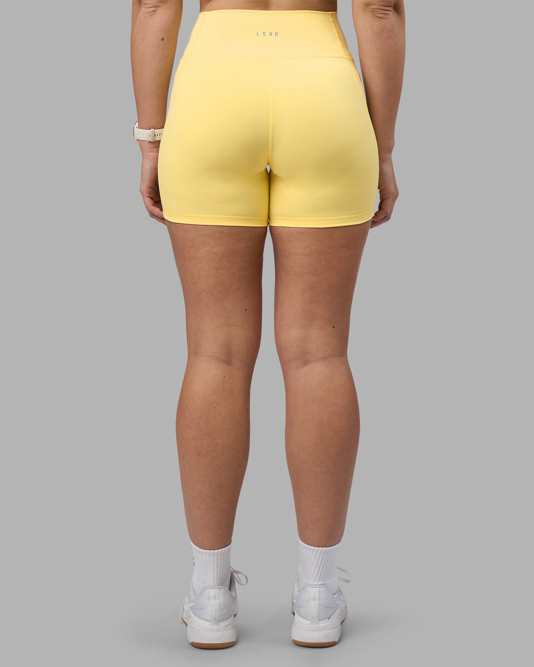 Woman wearing Fusion Ultra High-Rise 6&quot; Short Pockets - Lemon | Model:Amy | Size:M