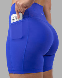 Woman wearing Fusion Ultra High-Rise 6" Short Pockets - Power Cobalt | Set:true | Angle:closeup | Model:Amy | Size:M