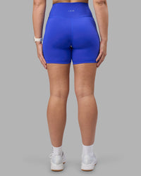 Woman wearing Fusion Ultra High-Rise 6" Short Pockets - Power Cobalt | Set:true | Angle:back | Model:Amy | Size:M