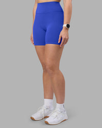 Woman wearing Fusion Ultra High-Rise 6" Short - Power Cobalt | Set:true | Angle:side | Model:Amy | Size:M