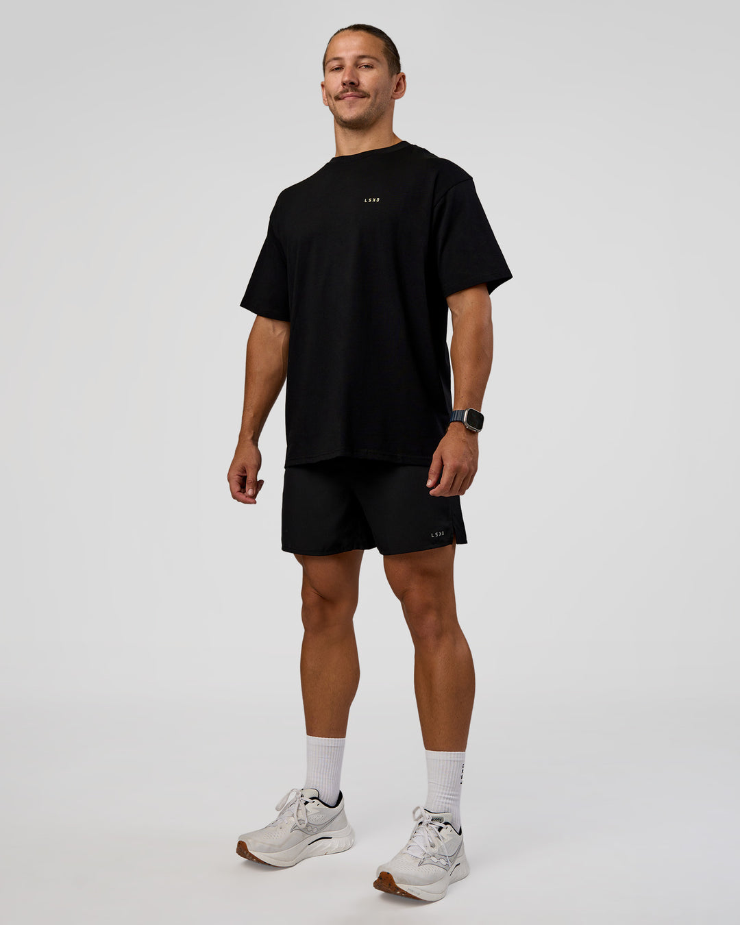 Man wearing High Run FLXCotton Oversized Tee - Black-Yellow Fizz | Model:Jaiden | Size:M