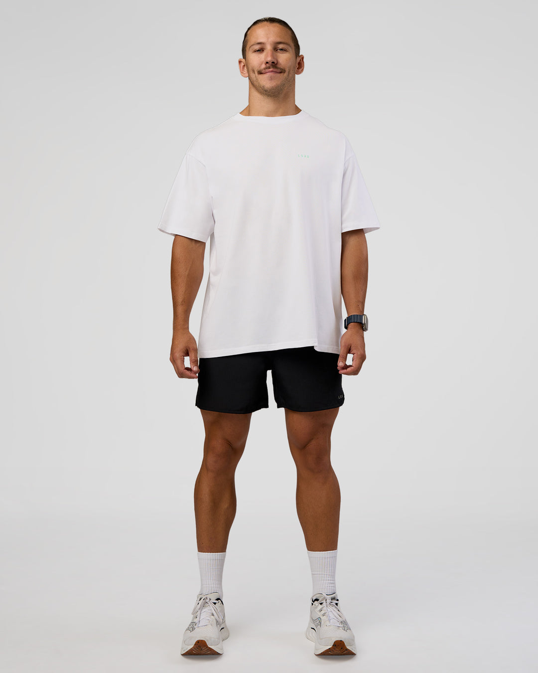 Man wearing High Run FLXCotton Oversized Tee - White-Jelly Mint | Model:Jaiden | Size:M