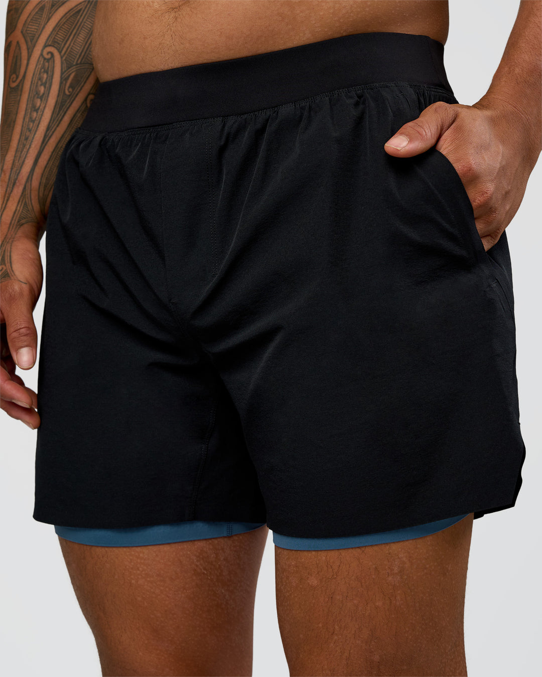 Man wearing Hybrid Lined 5" Short - Black-Indigo | Model:Daarian | Size:M