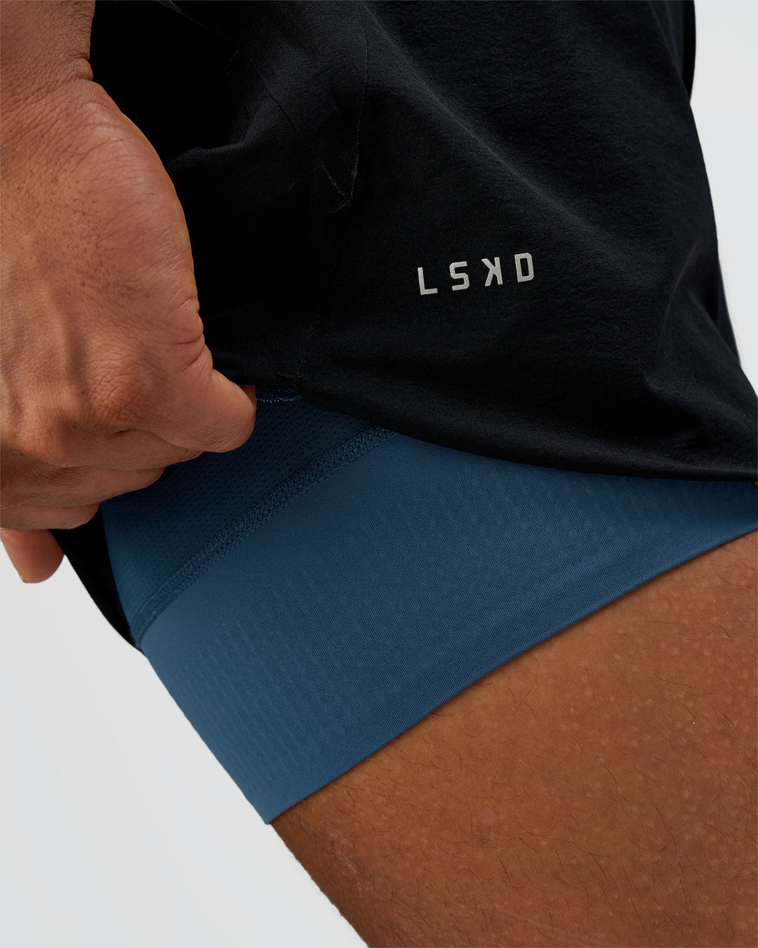 Man wearing Hybrid Lined 5" Short - Black-Indigo | Model:Daarian | Size:M