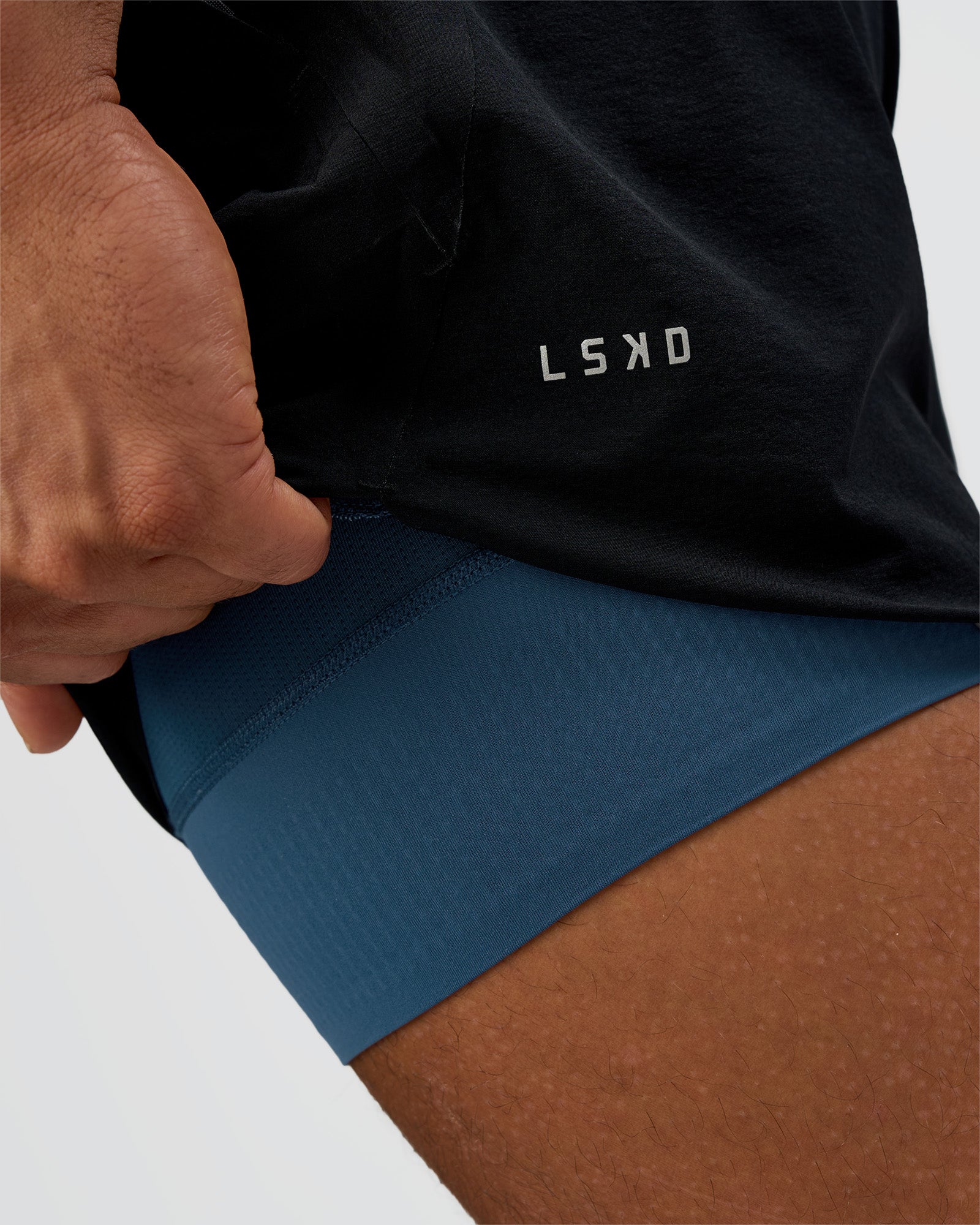 Man wearing Hybrid Lined 5" Short - Black-Indigo | Model:Daarian | Size:M