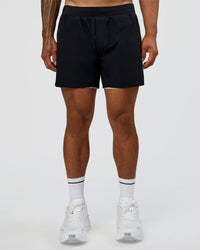 Man wearing Hybrid Lined 5" Short - Black-Shale Beige | Model:Daarian | Size:M