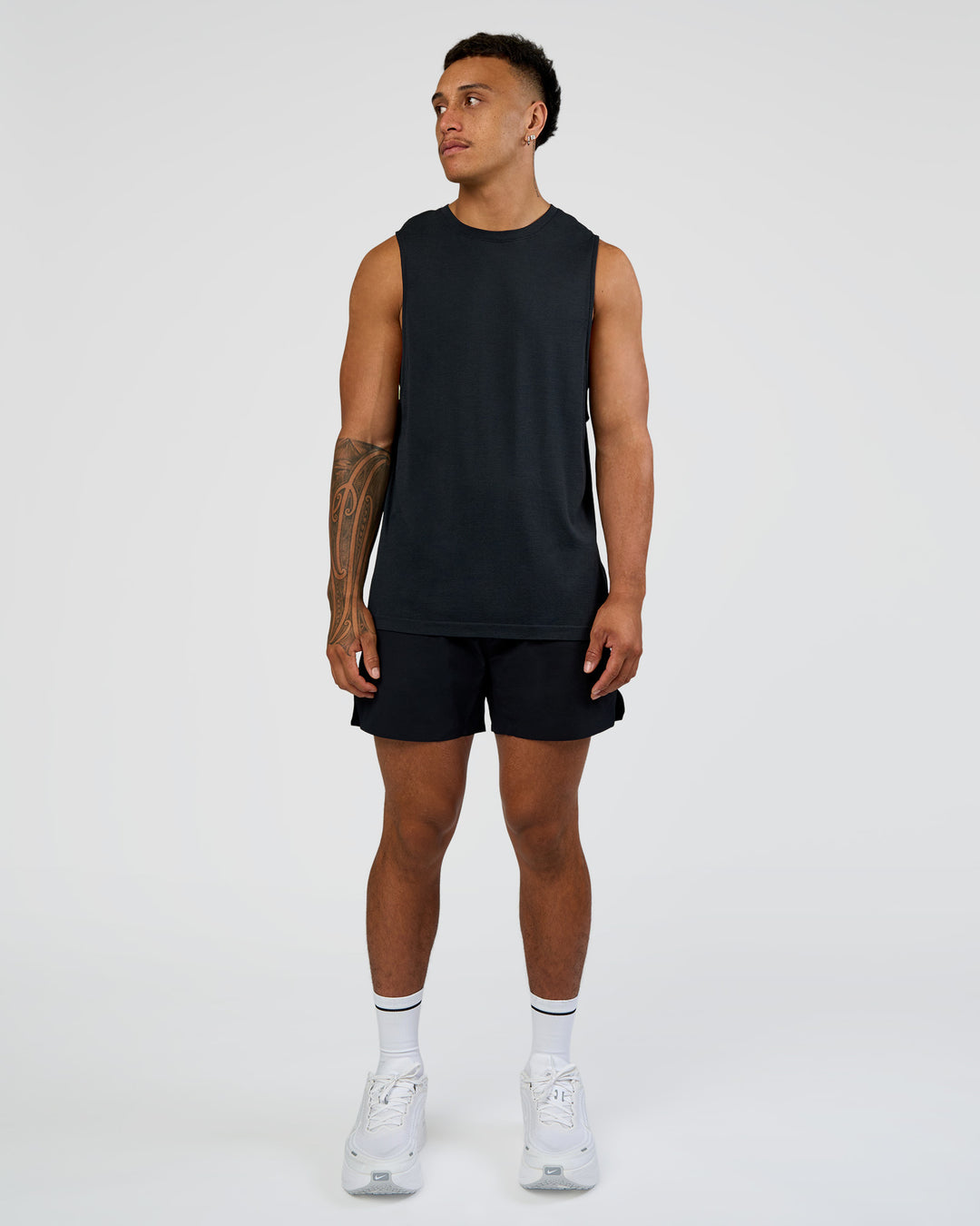 Man wearing Hybrid Lined 5" Short - Black-Shale Beige | Model:Daarian | Size:M
