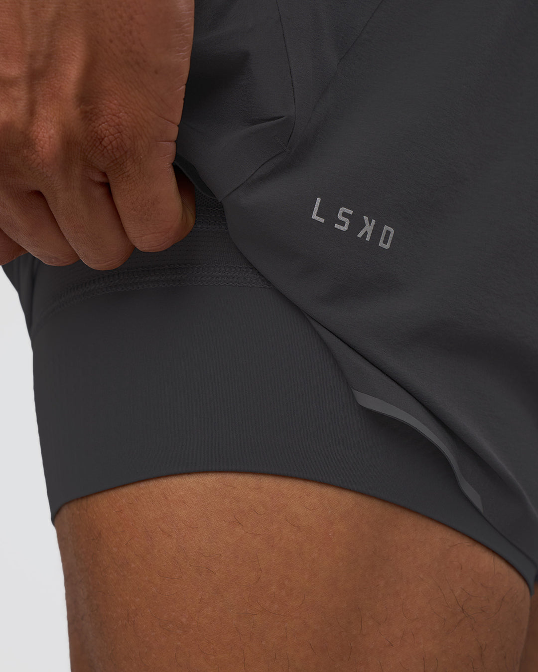 Man wearing Hybrid Lined 5" Short - Dark Storm | Model:Daarian | Size:M