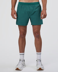 Man wearing Hybrid Lined 5" Short - Transformative Teal | Model:Konnor | Size:M