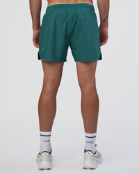Man wearing Hybrid Lined 5" Short - Transformative Teal | Model:Konnor | Size:M