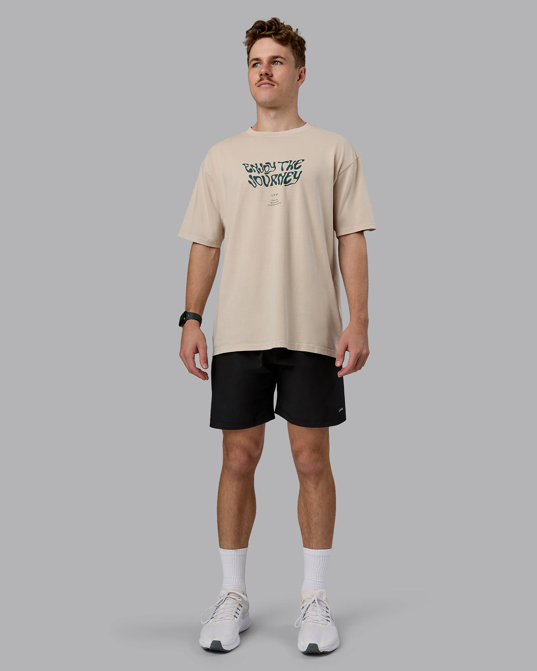 Man wearing Journey FLXCotton Oversized Tee in Washed Shale-Beige Dark-Moss | Model:Cameron | Size:M