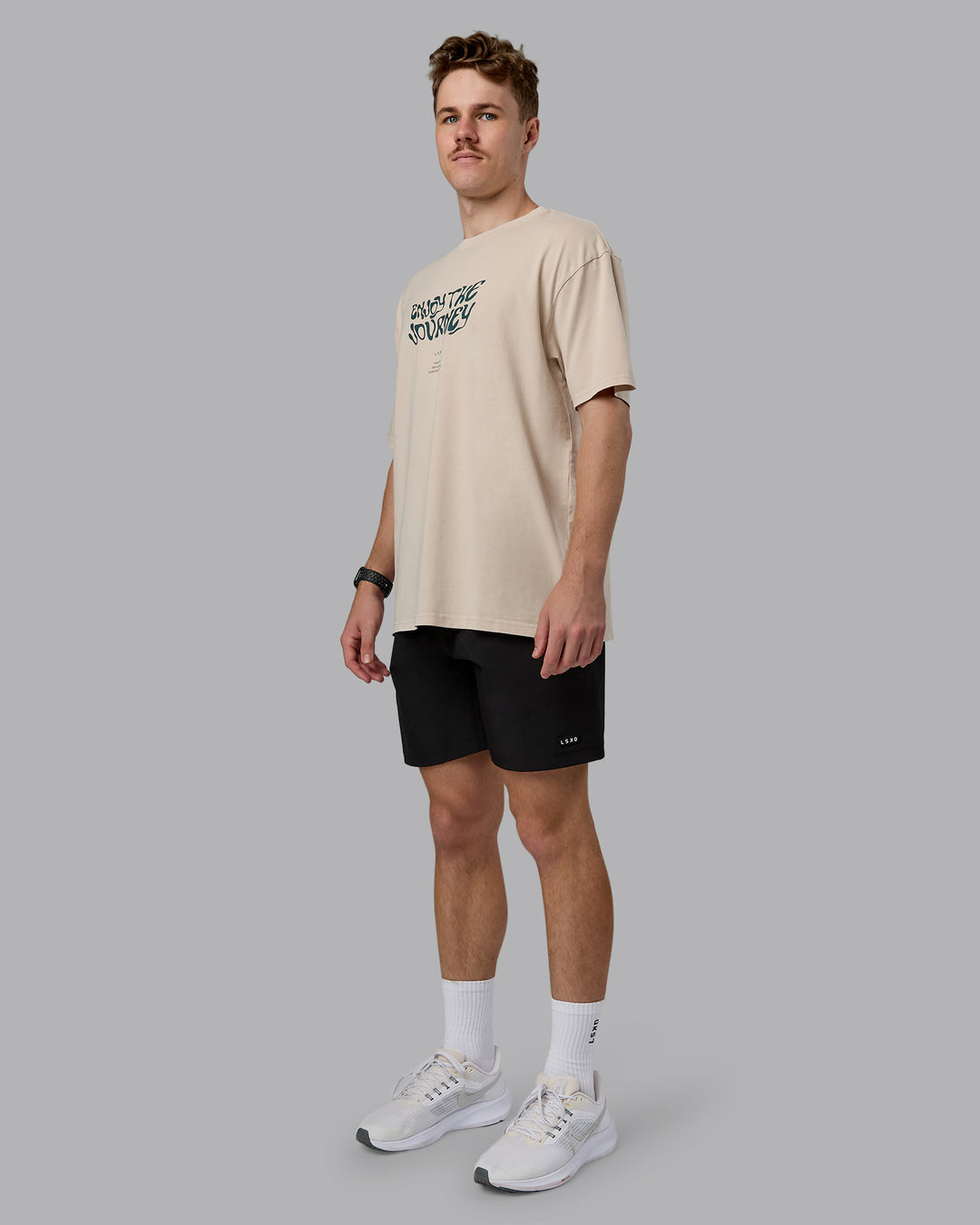 Man wearing Journey FLXCotton Oversized Tee in Washed Shale-Beige Dark-Moss | Model:Cameron | Size:M