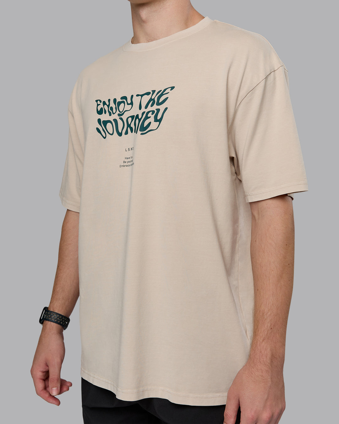Man wearing Journey FLXCotton Oversized Tee in Washed Shale-Beige Dark-Moss | Model:Cameron | Size:M