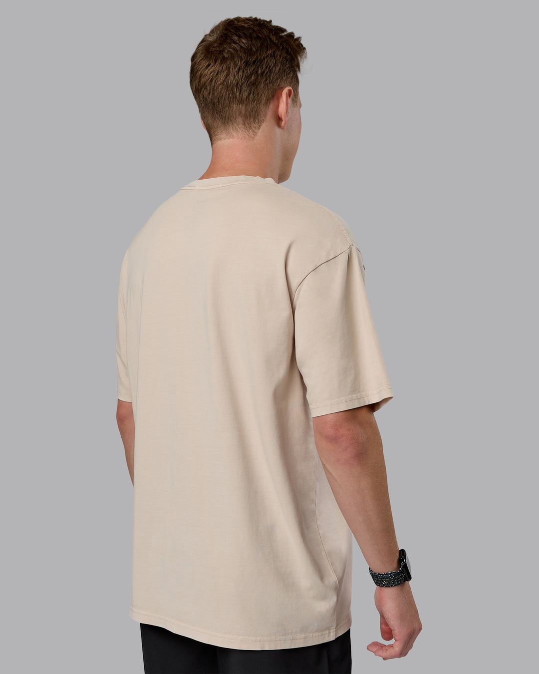 Man wearing Journey FLXCotton Oversized Tee in Washed Shale-Beige Dark-Moss | Model:Cameron | Size:M