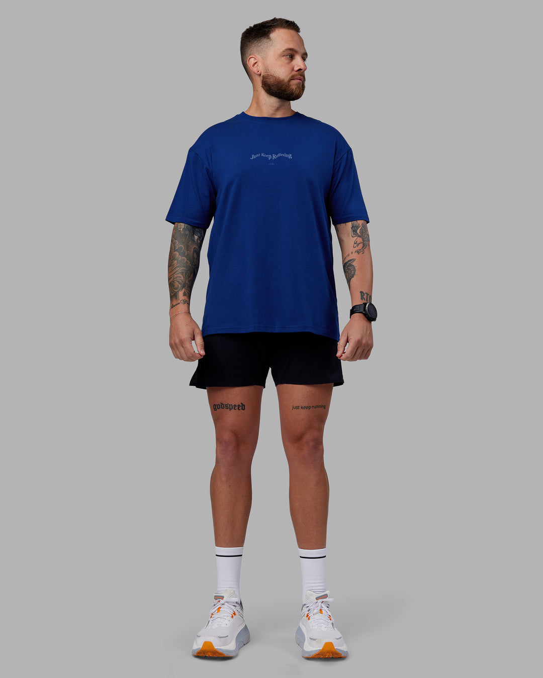 Man wearing Just Run FLXCotton Oversized Tee - Midnight Blue-Light Blue | Model:Macca | Size:M