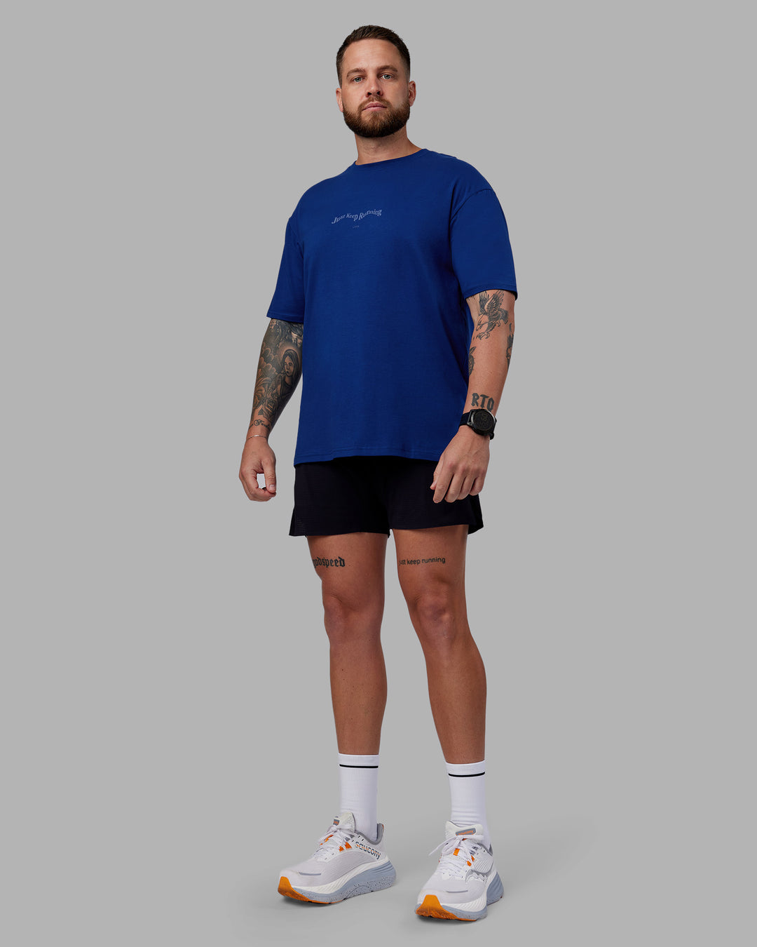 Man wearing Just Run FLXCotton Oversized Tee - Midnight Blue-Light Blue | Model:Macca | Size:M