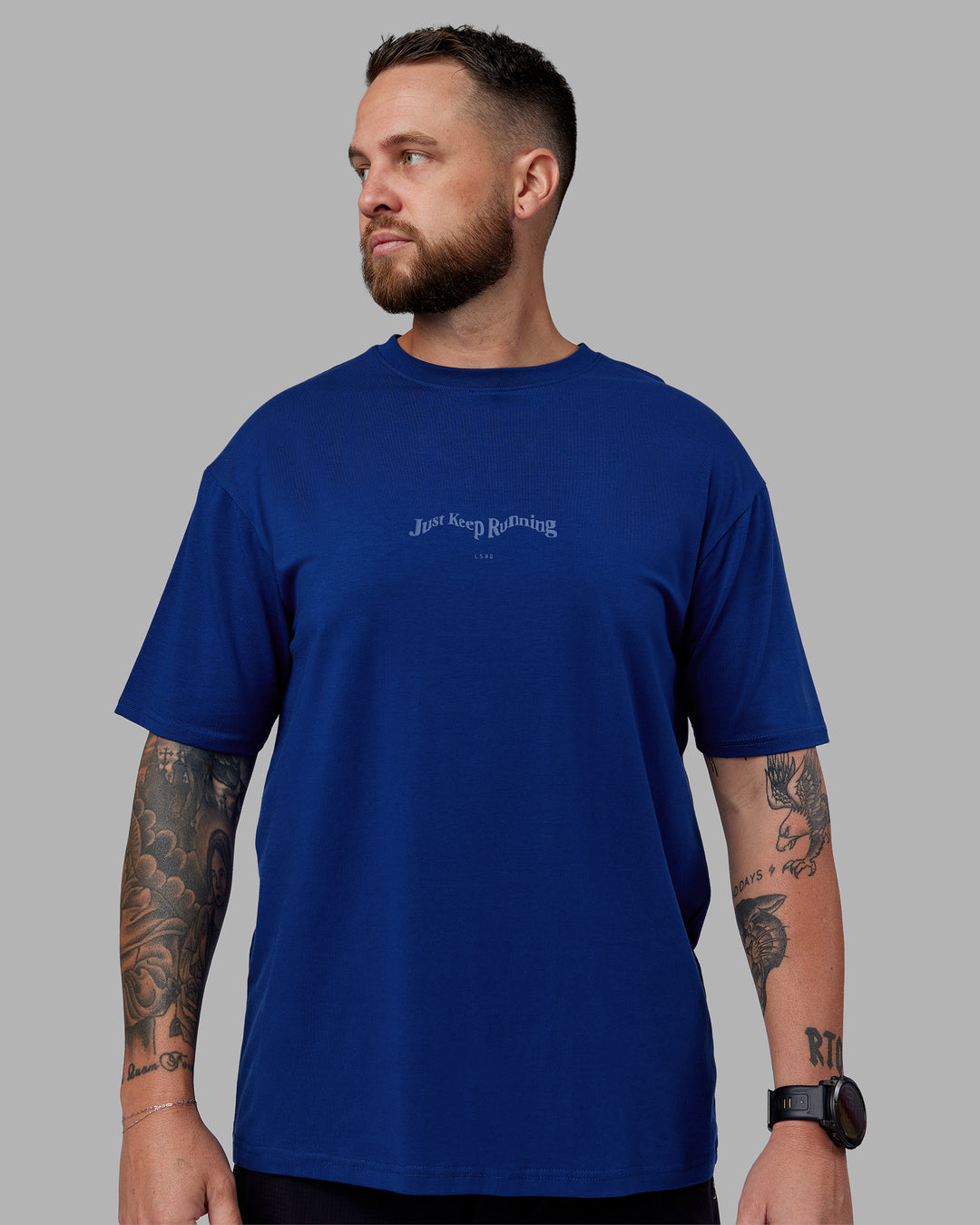 Man wearing Just Run FLXCotton Oversized Tee - Midnight Blue-Light Blue | Model:Macca | Size:M