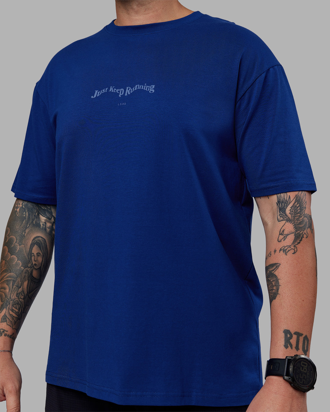 Man wearing Just Run FLXCotton Oversized Tee - Midnight Blue-Light Blue | Model:Macca | Size:M