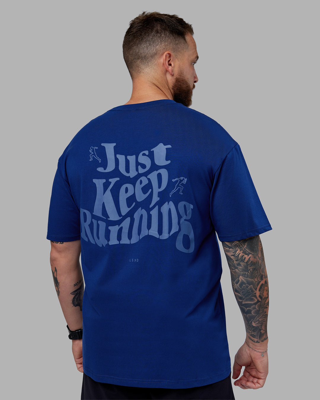 Man wearing Just Run FLXCotton Oversized Tee - Midnight Blue-Light Blue | Model:Macca | Size:M