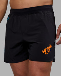 Man wearing Lift 6" Short - Black-Blue Atoll | Model:Jaiden | Size:M