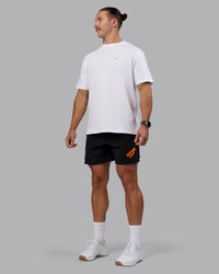 Man wearing Lift 6" Short - Black-Blue Atoll | Model:Jaiden | Size:M