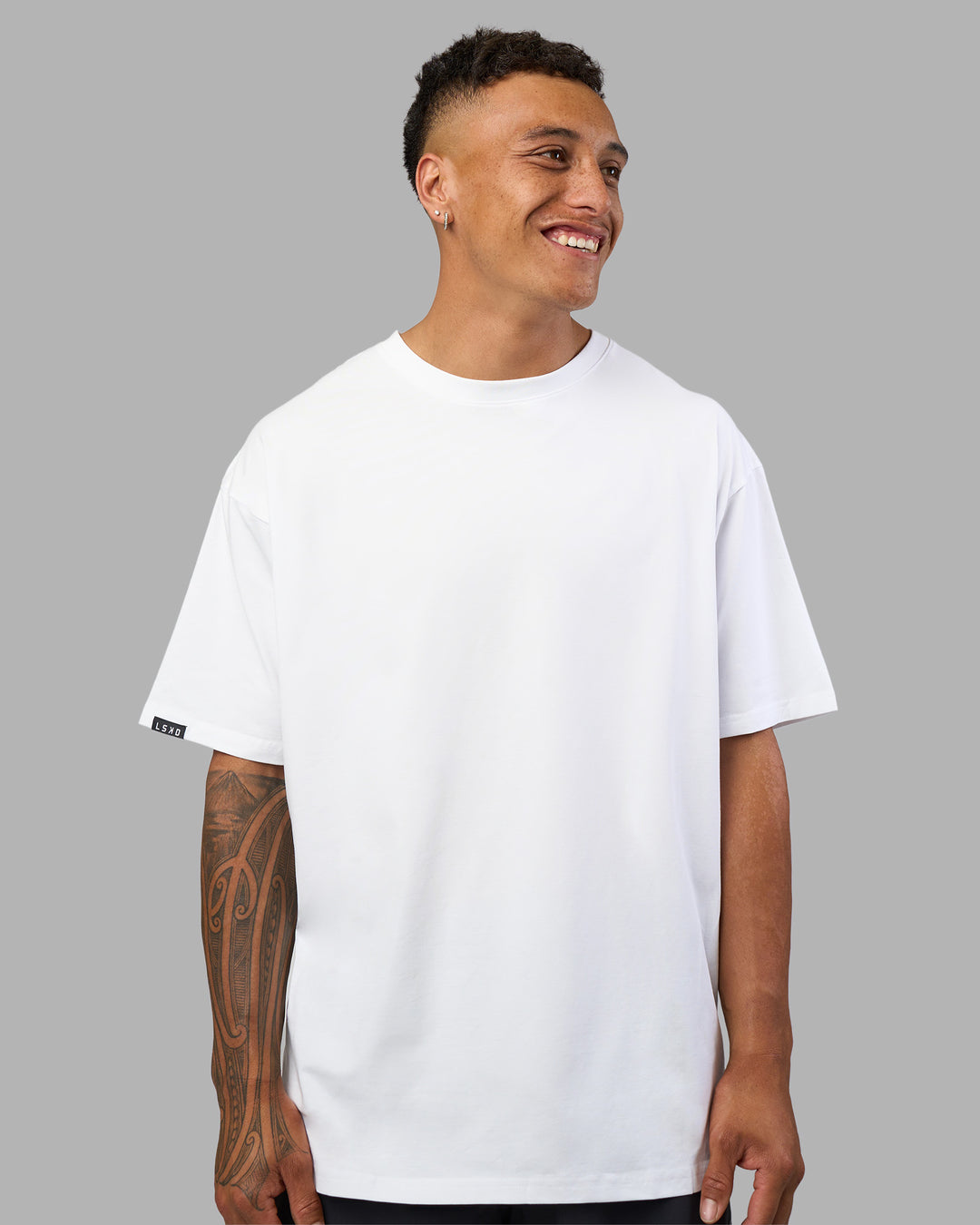 Man wearing Lilz Lifting Club FLXCotton Oversized Tee - White | Model:Daarian | Size:M