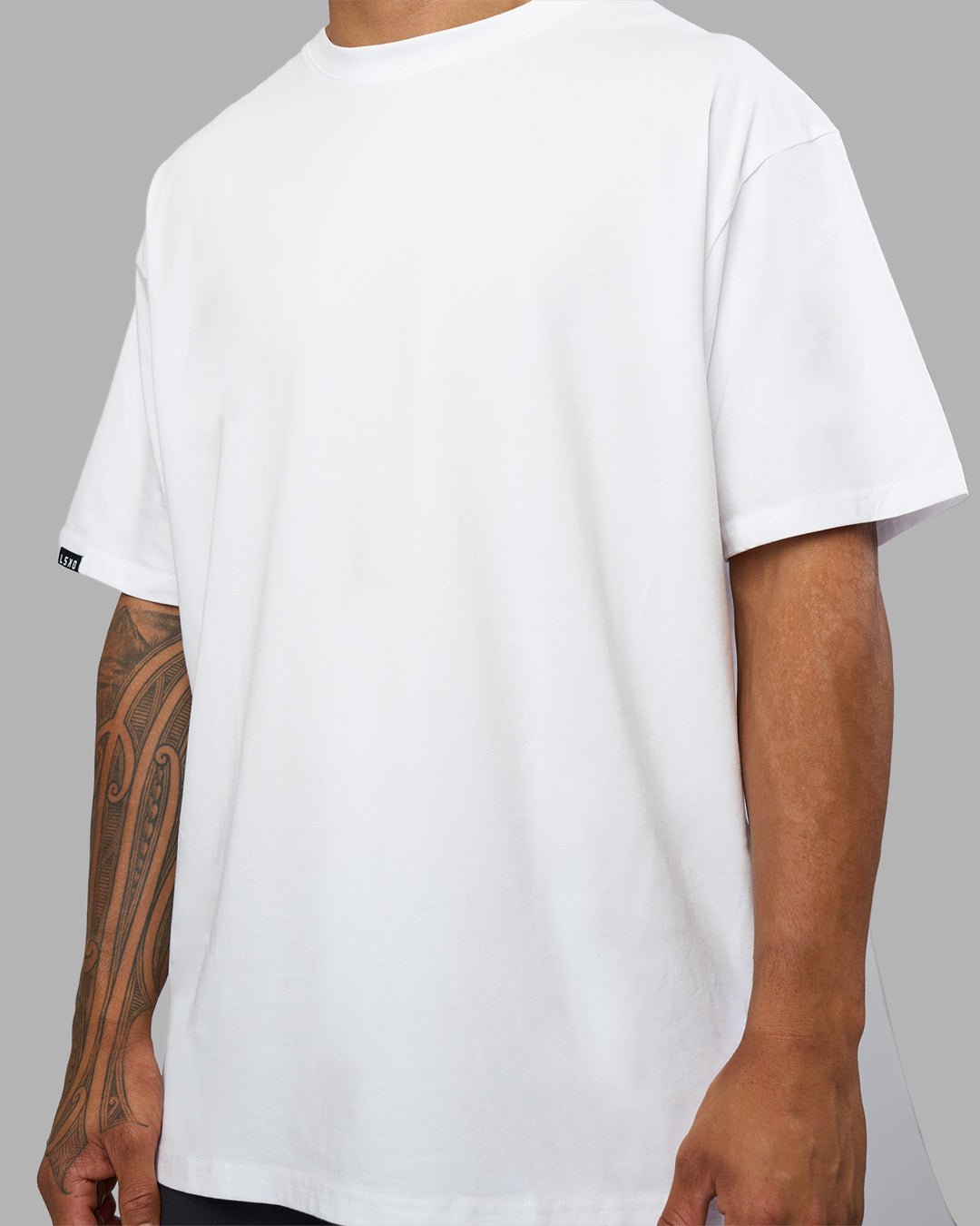 Man wearing Lilz Lifting Club FLXCotton Oversized Tee - White | Model:Daarian | Size:M