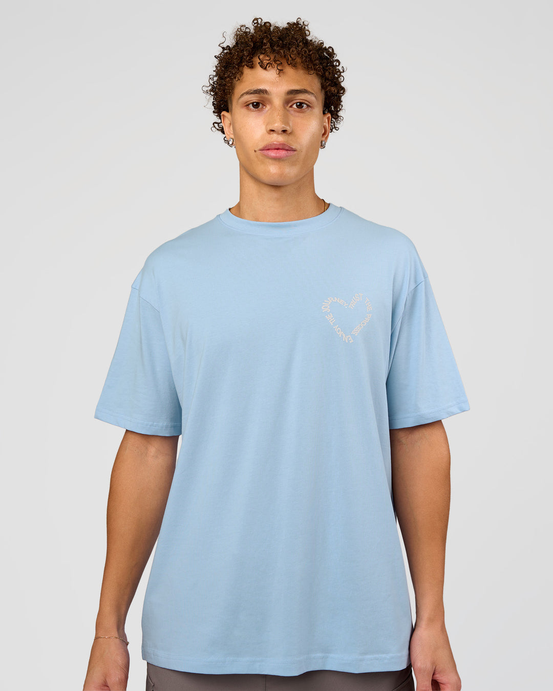 Man wearing Love The Process FLXCotton Oversize Tee - Open Air-Off White | Model:Leandro | Size:M