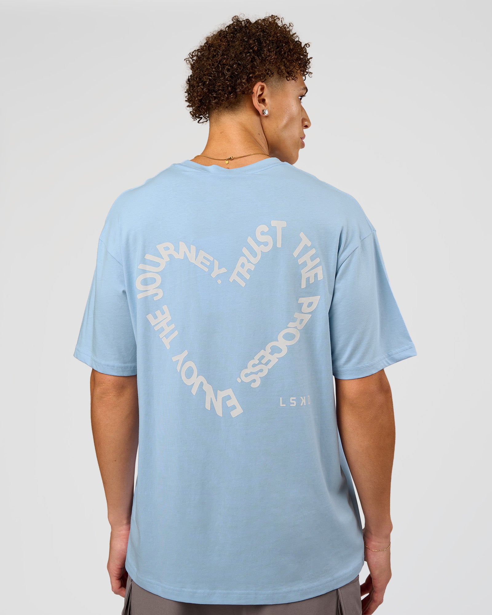 Man wearing Love The Process FLXCotton Oversize Tee - Open Air-Off White | Model:Leandro | Size:M