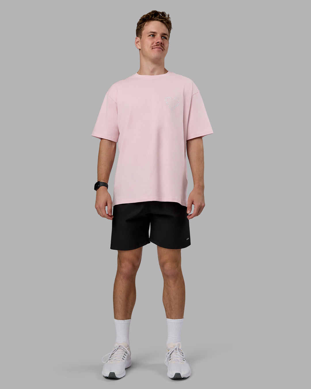 Man wearing Love The Process FLXCotton Oversize Tee - Petal Pink-White | Model:Cameron | Size:M