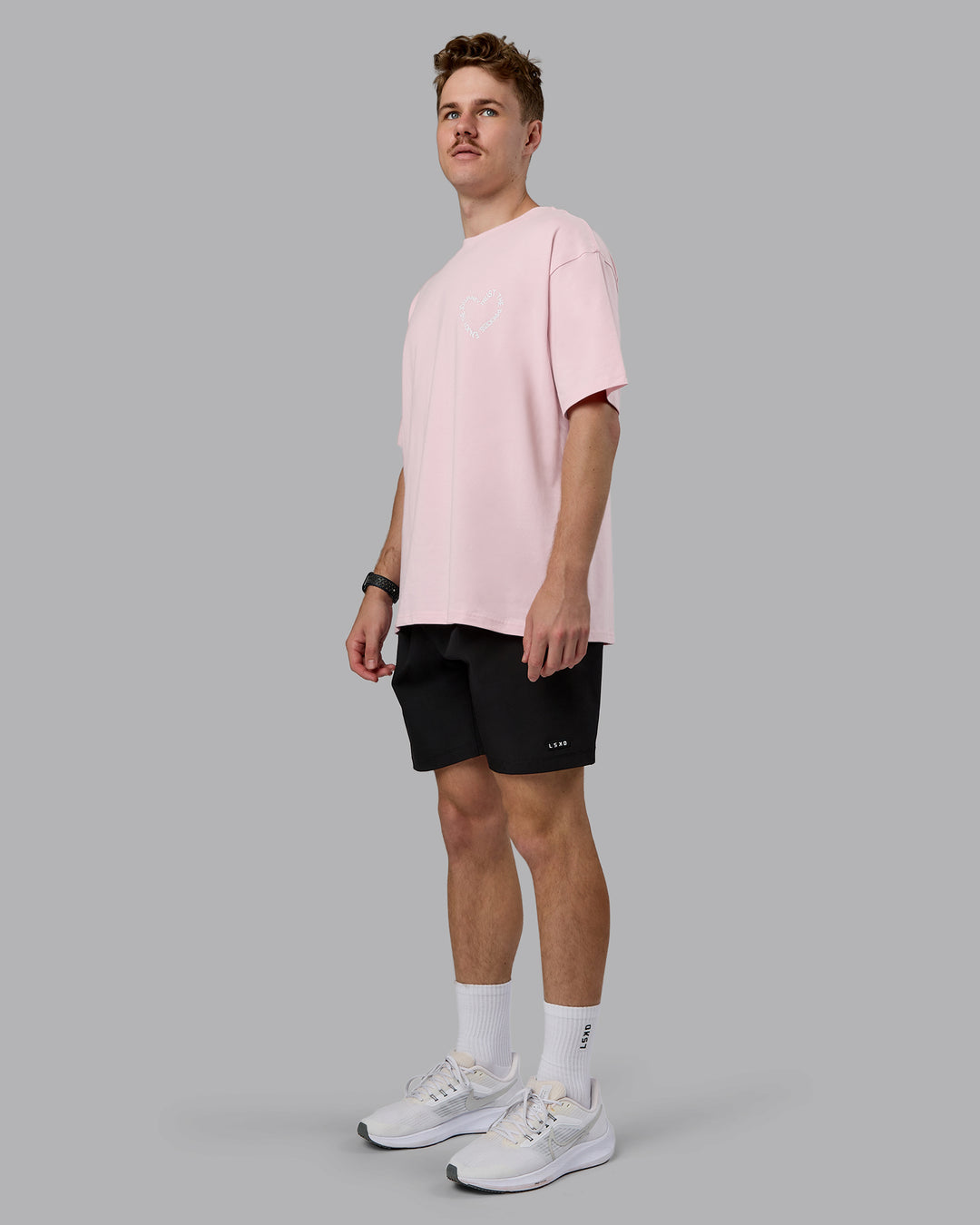 Man wearing Love The Process FLXCotton Oversize Tee - Petal Pink-White | Model:Cameron | Size:M