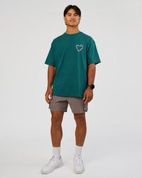 Man wearing Love The Process FLXCotton Oversize Tee - Transformative Teal-Marshmallow | Model:George | Size:M
