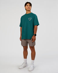 Man wearing Love The Process FLXCotton Oversize Tee - Transformative Teal-Marshmallow | Model:George | Size:M