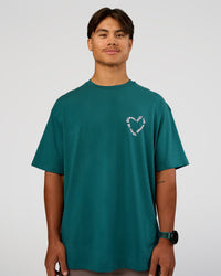 Man wearing Love The Process FLXCotton Oversize Tee - Transformative Teal-Marshmallow | Model:George | Size:M