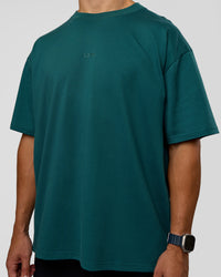 Man wearing MVP 2.0 Oversized Tee - Transformative Teal | Model:Jaiden | Size:M