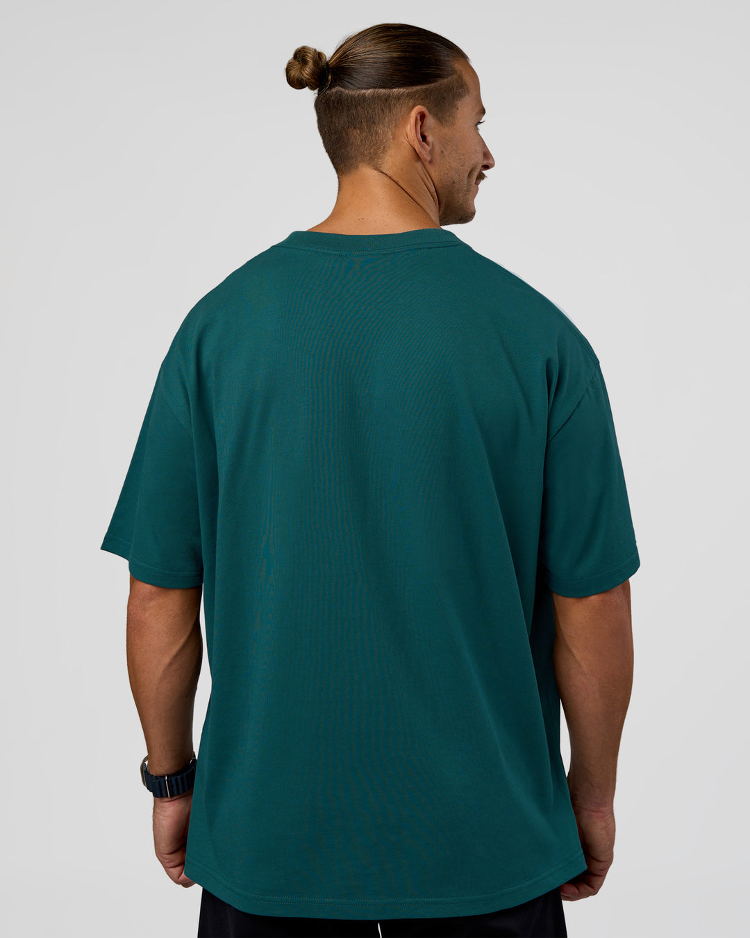Man wearing MVP 2.0 Oversized Tee - Transformative Teal | Model:Jaiden | Size:M